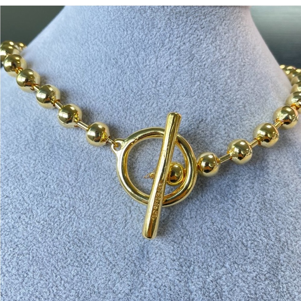 Gold tone beaded necklace with toggle